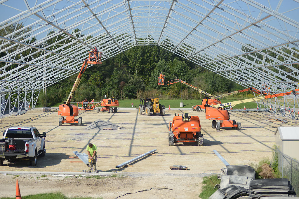 Construction workers from Structures Unlimited work on the new building for the Columbia Canine Sports Center on Thursday